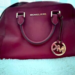 Michael Kors maroon hand bag. Gently used. Great for a fall look!
